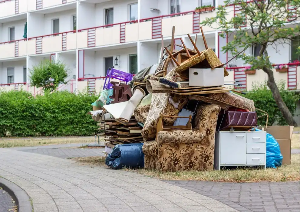 A pile of furniture in front of an apartment building